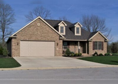 a brick home with a garage and driveway